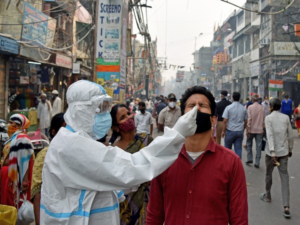 A health worker in personal protective equipment (PPE) collects a nasal sample from a man at the Sadar Bazar market With spike of 50,209 cases, India's COVID-19 tally reaches 83,64,086